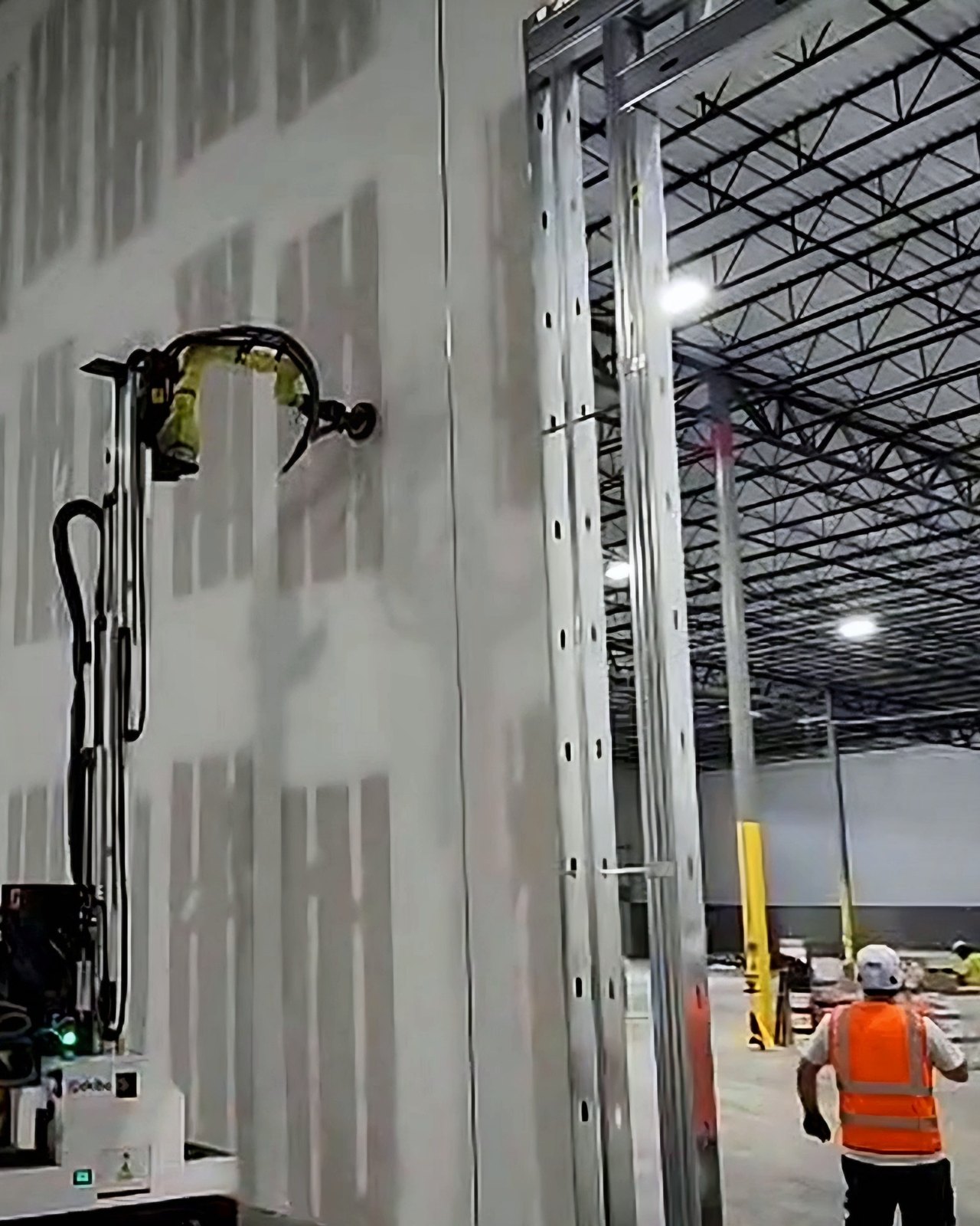 Okibo EG7+ sanding near the top of a 24 ft warehouse wall